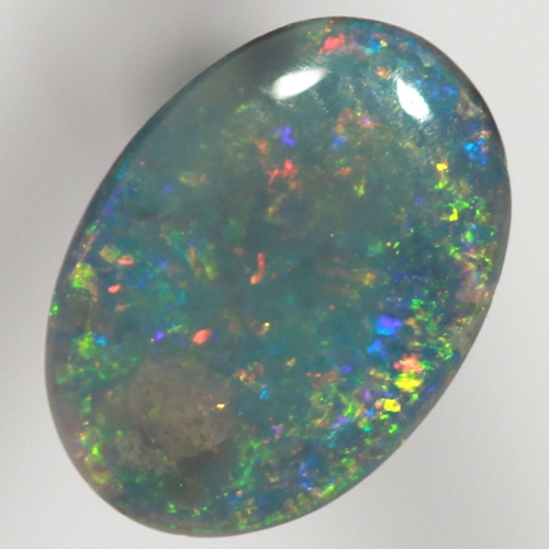 SOLID BLACK OPAL Sparkling reds, yellows over ocean blue